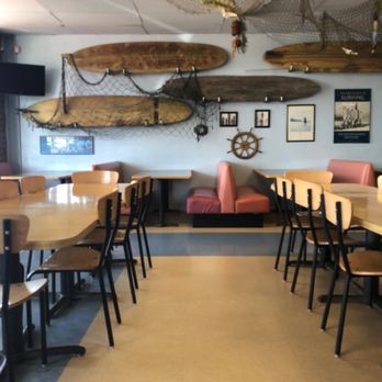 Surf Shack Pizza - a dining area with tables and chairs - Pizza Near Me - Grants, New Mexico