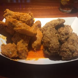 Domenic's Pub - The breaded wings. Spicy garlic on left. Cajun dry rub on right.