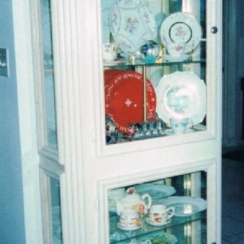 Wood Master Homes - a china cabinet with glass doors - General Contractors Near Me