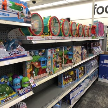 CVS Pharmacy - Toys - Shelves stocked with toys including bubble machines, playsets, and plush toys in a retail store aisle. - Drugstores Near Me - Denton, Texas