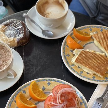 Caffe Greco - Double mocha, cappuccino, salmon bagel, turkey panini, orange/chocolate cookie, cannoli (not shown) - Coffee & Tea Near Me - San Francisco, California Caffe Greco - Double mocha, cappuccino, salmon bagel, turkey panini, orange/chocolate cookie, cannoli (not shown) - Coffee & Tea Near Me - San Francisco, California