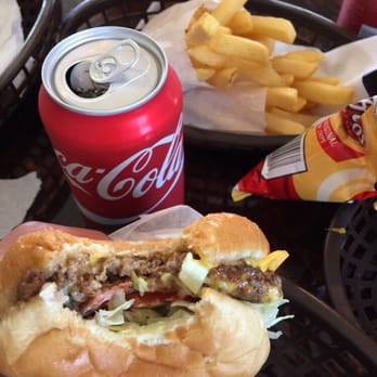 La Guera - a person holding a hot dog and french fries - Convenience Stores Near Me - Brownsville, Texas