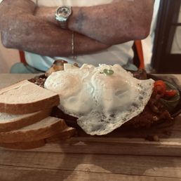 Irish 'eggs benedict' ( Eggs over traditional hash, with sliced avocado, tomato, and a side of sourdough toast)