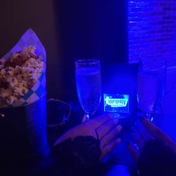 Stir Crazy Comedy Club - Our table, champagne and gourmet carmel bacon popcorn.