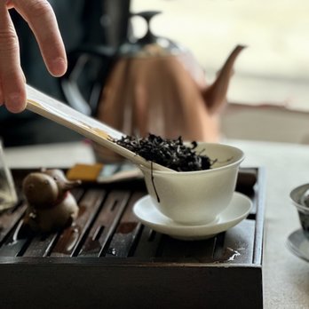 West China Tea House - a person pouring tea into a bowl - Tea Rooms Near Me - Austin, Texas West China Tea House - a person pouring tea into a bowl - Tea Rooms Near Me - Austin, Texas