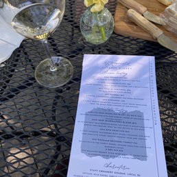 a menu and a glass of wine a menu and a glass of wine