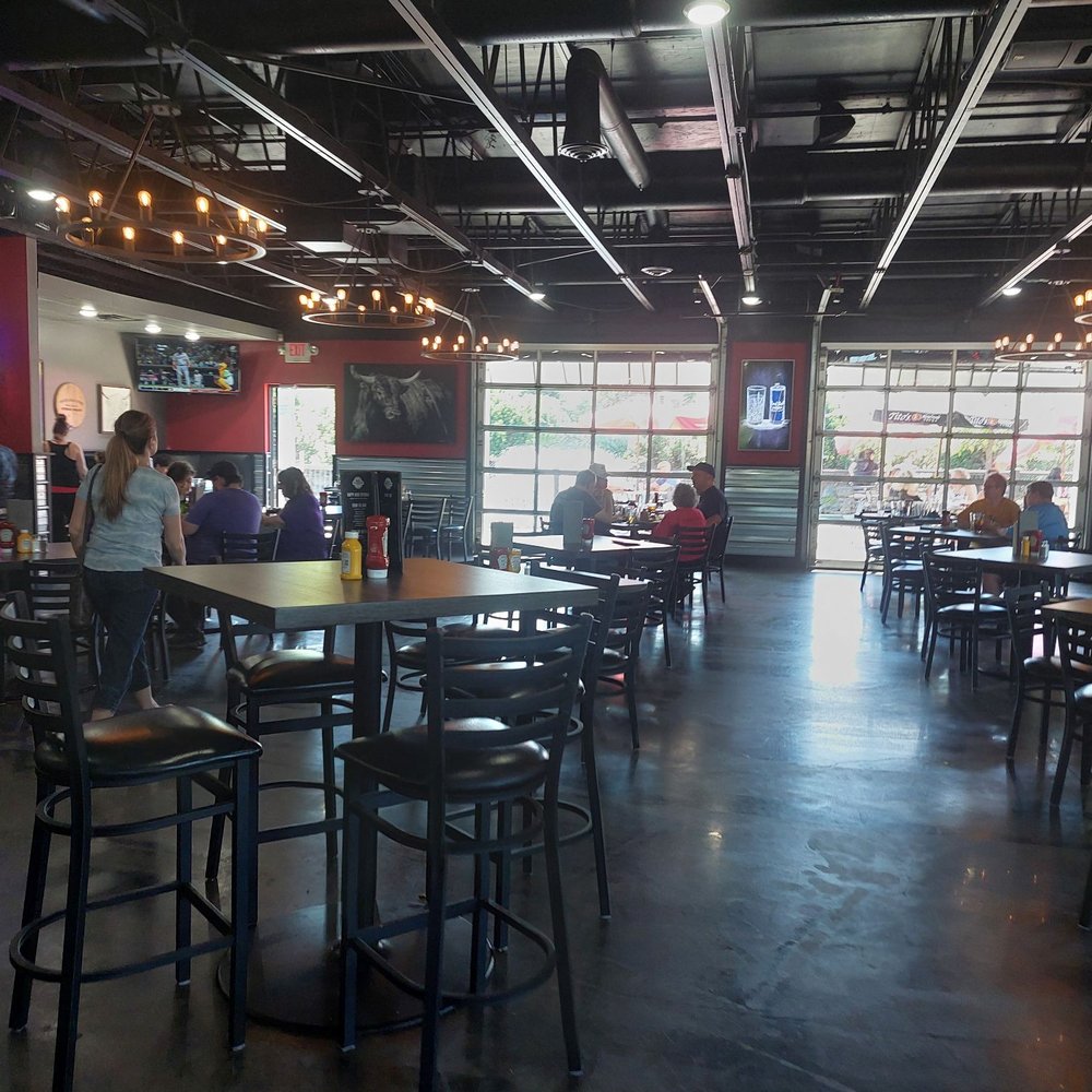 Mad Cow - the inside of a restaurant with tables and stools - Burgers Near Me - Eagan, Minnesota Mad Cow - the inside of a restaurant with tables and stools - Burgers Near Me - Eagan, Minnesota