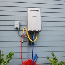 Tankless Bros - Tankless Water Heater being flushed. Hoses connect to the tankless water heater by passes and the submersible pump.