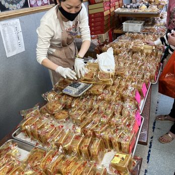 AA Bakery & Cafe - Lady helping a customer with her mooncakes order. - Bakeries Near Me - San Francisco, California AA Bakery & Cafe - Lady helping a customer with her mooncakes order. - Bakeries Near Me - San Francisco, California