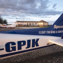 Spectrum Airways - Cessna 172R parked out front of the Spectrum Airways Flight School.