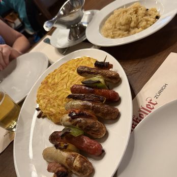 Zeughauskeller - A tasting of various sausages with rosti (like hash browns) and some sauerkraut - Swiss Food Near Me - Zürich, ZH