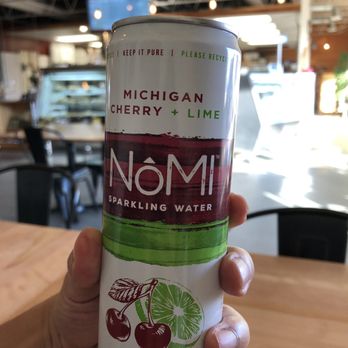 Raduno - a person holding a can of nomi sparkling water - Delis Near Me - Traverse City, Michigan Raduno - a person holding a can of nomi sparkling water - Delis Near Me - Traverse City, Michigan