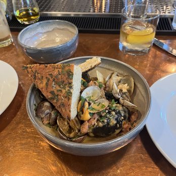 COMMUNION Restaurant and Bar - Sautéed Clams and Mussels with Laotian sausage in a coconut sauce. - Soup Near Me - Seattle, Washington