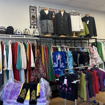 Nura Express Tailor - A retail store interior showcasing various clothing items on racks, mannequins dressed in jackets and shirts, and accessories like hats and scarves. - Sewing & Alterations Near Me - Chicago, Illinois