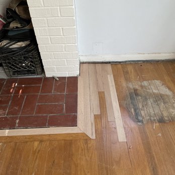 Madeira Flooring - Repairing plans around the fire place and fixing some gaps between the brick and floor - Flooring Near Me Madeira Flooring - Repairing plans around the fire place and fixing some gaps between the brick and floor - Flooring Near Me