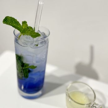 Luvwoo Bar - a blue drink with a straw and mint - Cocktail Bars Near Me - Saint Louis, Missouri