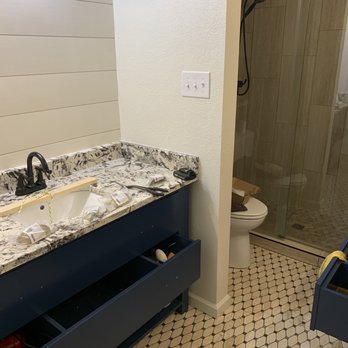Simple Man - a bathroom with a sink, toilet, and shower - Handyman Near Me Simple Man - a bathroom with a sink, toilet, and shower - Handyman Near Me