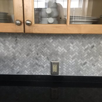 Versatile Builders - a kitchen with a black countertop - Tiling Near Me - Quincy, Massachusetts