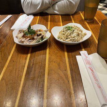 Magic Noodle - a man sitting at a table with two plates of food - Noodles Near Me - North York, Ontario