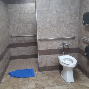 Love's Travel Stop - Toilet right in front is the shower stall behind that wall. Blue complimentary towel. - Gas Stations Near Me - Williams, Arizona Love's Travel Stop - Toilet right in front is the shower stall behind that wall. Blue complimentary towel. - Gas Stations Near Me - Williams, Arizona