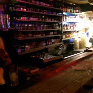 Photo of Dan's Cafe - Washington, DC, United States. Liquor bottles lining the back of the bar