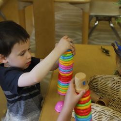 Young boy stacks colorful blacks at MC-CDC