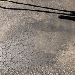 Car Wash USA Express - One of the many built up patches of oil among the piles of dirt right where you can step into so you can track it into your "clean" car.