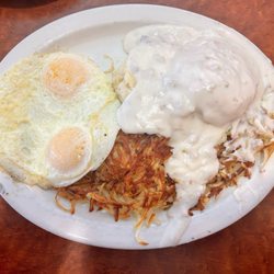 Wade's Cafe - Biscuits And Gravy with hash browns and two over medium eggs.