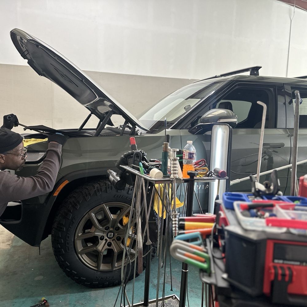 Dent Wolf - Lenny repairing a dent in the front left Rivian R1T fender. - Body Shops Near Me - Arlington, Texas Dent Wolf - Lenny repairing a dent in the front left Rivian R1T fender. - Body Shops Near Me - Arlington, Texas
