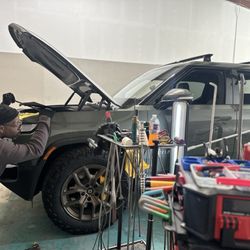 Dent Wolf - Lenny repairing a dent in the front left Rivian R1T fender.