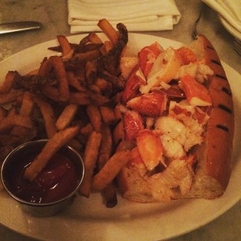 Neptune Oyster - Hot lobster roll over flowing with lobster with nice hand cut fries on the side - Seafood Near Me - Boston, Massachusetts Neptune Oyster - Hot lobster roll over flowing with lobster with nice hand cut fries on the side - Seafood Near Me - Boston, Massachusetts