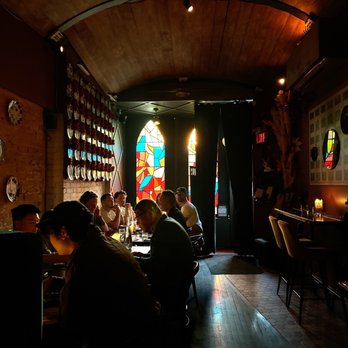 Pastiche - a group of people sitting at a table - Cocktail Bars Near Me - Toronto, Ontario Pastiche - a group of people sitting at a table - Cocktail Bars Near Me - Toronto, Ontario