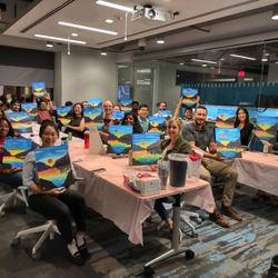 Paint the Town - Group photo of people holding up paintings.