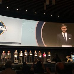 UltraSpeaking - Tristan smiling in front of 3000 people as he shares the stage with the other World Championship of Public Speaking finalists