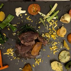 Momentos - Black pork cheek surrounded by creatively prepared vegetables. Best piece of meat ever.