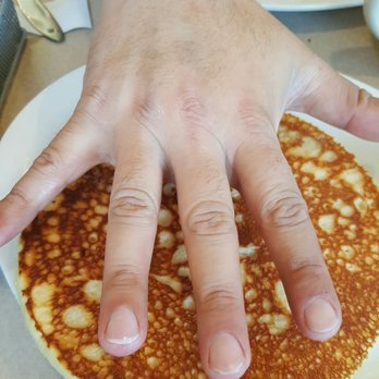 Silver Grill Cafe - Huge a** pancake. His hand is faaaarrr away from that pancake, and it still is as big as his hand. - Breakfast & Brunch Near Me - Fort Collins, Colorado Silver Grill Cafe - Huge a** pancake. His hand is faaaarrr away from that pancake, and it still is as big as his hand. - Breakfast & Brunch Near Me - Fort Collins, Colorado