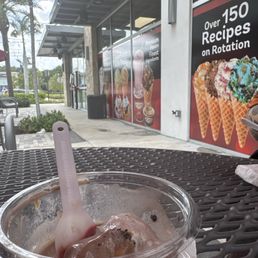 Mostly eaten ice cream with takeout window in the background.