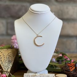 Crescent shaped diamond pendant