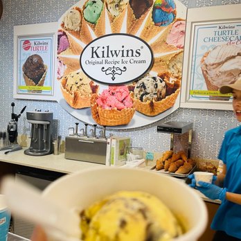 Kilwins Ice Cream - Chocolate - Fudge - a woman holding a cup of ice cream - Chocolatiers & Shops Near Me - Williamsburg, Virginia
