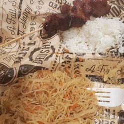 Ejelyn's Kitchen - Was so hungry I forgot to take a picture right after opening the box.  Pork BBQ skewer (half eaten ) with rice and pancit.