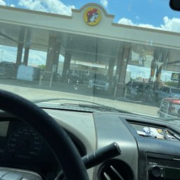 a view of a gas station from inside a car a view of a gas station from inside a car