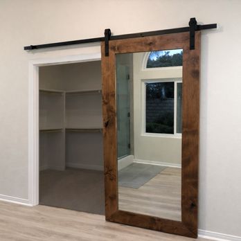 Coastal Craftsman - Sliding barn door on a black industrial track. Custom-built for a walk-in closet, replacing a traditional swinging door. - Handyman Near Me Coastal Craftsman - Sliding barn door on a black industrial track. Custom-built for a walk-in closet, replacing a traditional swinging door. - Handyman Near Me