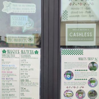 Magick Matcha - Menu as of 04.19.2025 - The window shows business hours, a cashless payment sign, and a menu listing matcha drinks and prices at Magick Matcha in Austin, TX. - Coffee & Tea Near Me - Austin, Texas