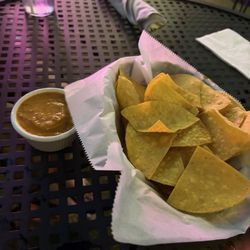 Very tasty salsa with maybe regular salsa and crema? And chips.