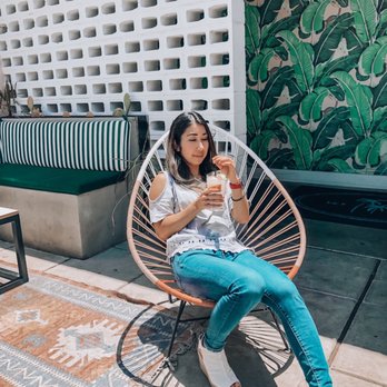 Lost & Found - a woman sitting in a chair with a drink - Bars Near Me - El Paso, Texas