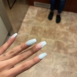 VA Nails - Full Set: light blue pattern glitter and V French tips.