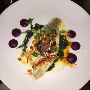 Salinas - Sea bass cooked to perfection w| raisins & pinenuts on a bed of greens - Spanish Near Me - New York, New York Salinas - Sea bass cooked to perfection w| raisins & pinenuts on a bed of greens - Spanish Near Me - New York, New York