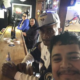 a group of people sitting at a bar