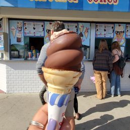 a person holding an ice cream cone a person holding an ice cream cone