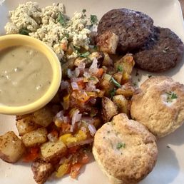 Tofu scramble, vegan sausage, home fries, biscuits, and vegan gravy.
